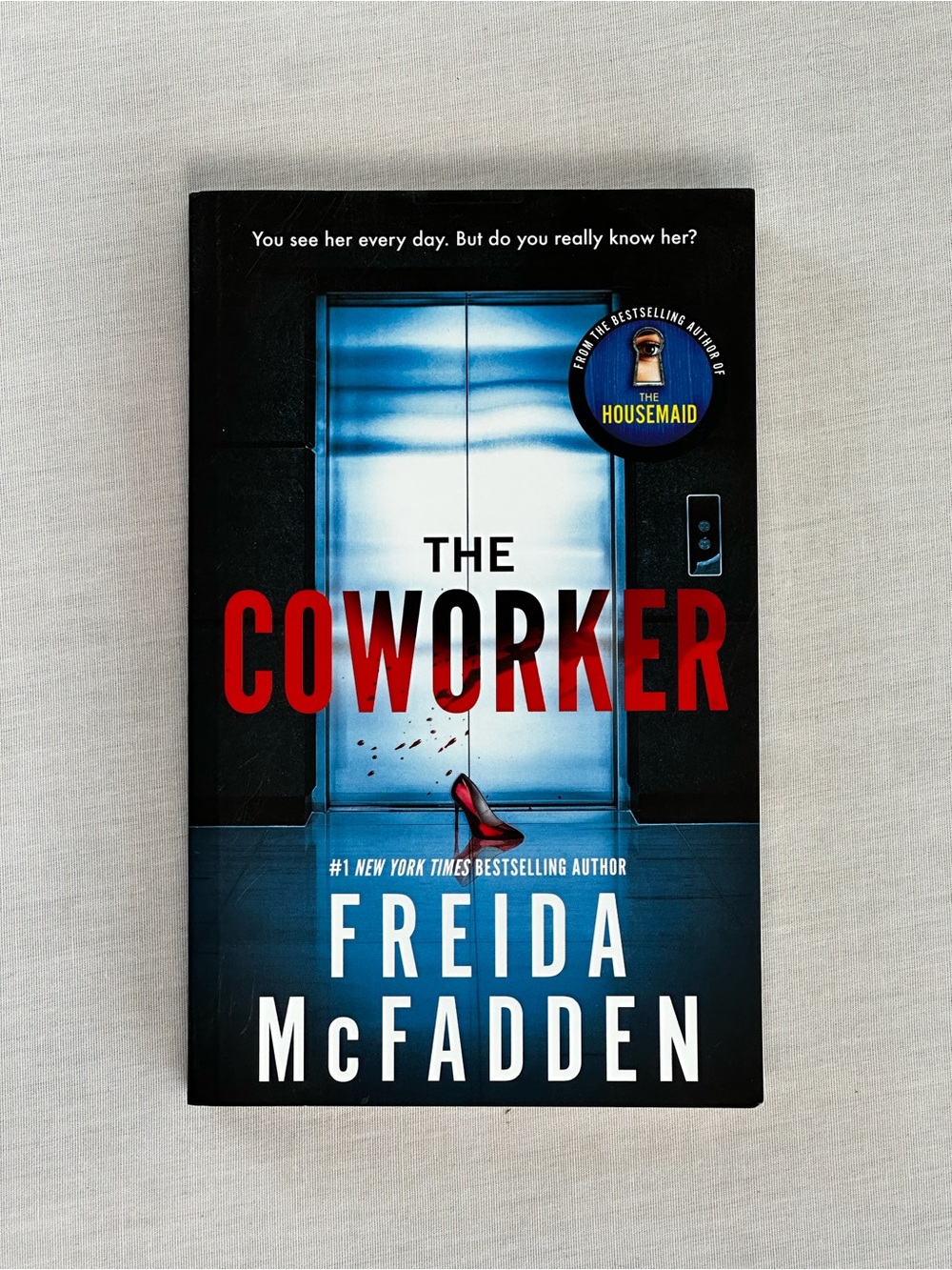 The Coworker by Freida McFadden - Black/Blue Paperback Thriller